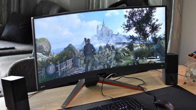 The BenQ Mobiuz EX3410R gaming monitor on a desk, running Sniper Elite 5.