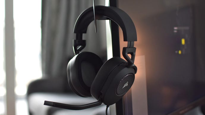 The Corsair HS65 Stereo gaming headset, hanging on monitor's pop-up headset hook.