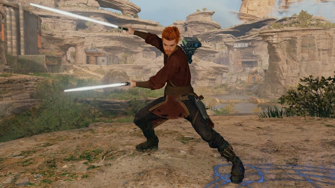 Cal Kestis, the main character of Star Wars Jedi: Survivor, standing in front of a rocky landscape and brandishing two lightsaber blades